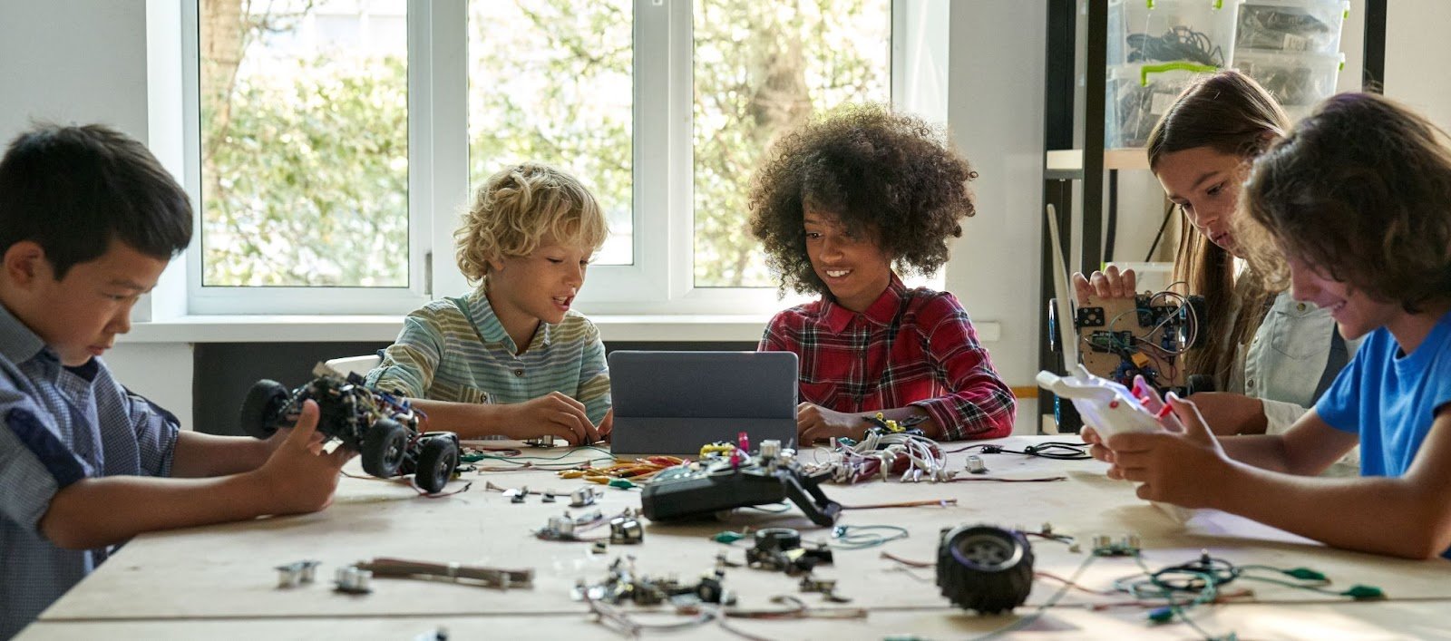 Children together at a table engineering.